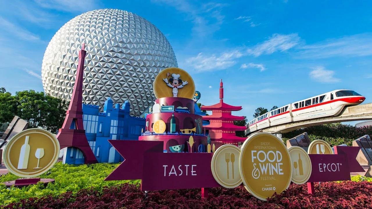 epcot international food and wine festival sign with spaceship earth and monorail