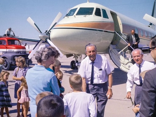 walt disney in front of his plane