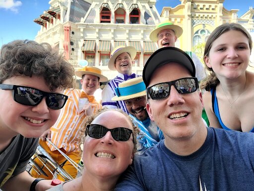 smith family with dapper dans main street magic kingdom